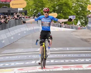 Jonas Vingegaard celebrates as he crosses the line to win stage nine