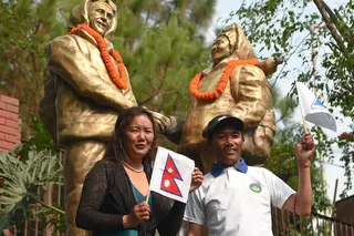 Nepali mountaineers Kami Rita Sherpa and Lhakpa Sherpa pose for a picture in front of the statues of Tenzing Norgay and Sir Edmund Hillary to mark the 11th International Everest Day in Kathmandu on May 29, 2018.