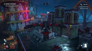 Lego Batman: Legacy of the Dark Knight screenshot showing traversal over a theme park at night