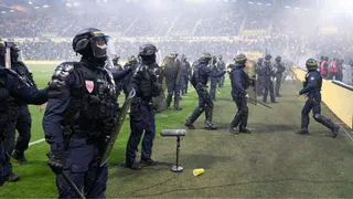 Anti-riot police officers prevent Nantes' supporters from invading the picth during the French L1 football match between FC Nantes and Toulouse FC at the Stade de la BeaujoireLouis Fonteneau in Nantes, western France, on May 17, 2026. (Photo by Sebastien Salom-Gomis / AFP via Getty Images)