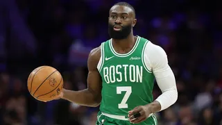 Boston Celtics guard Jaylen Brown dribbling basketball against Philadelphia 76ers at Xfinity Mobile Arena