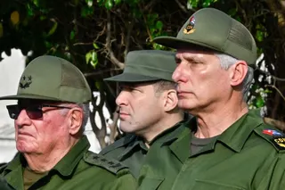 Cuba's President Miguel Diaz-Canel (R), Colonel Raul Guillermo Rodriguez Castro (C), grandson of former President Raul Castro, and Armed Forces Minister General Alvaro Lopez Miera attend the funeral of the 32 Cuban soldiers killed during the US incursion in Venezuela at Colon cemetery in Havana on January 16, 2026.