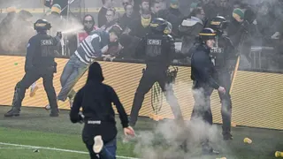 Anti-riot police officers spray tear gas at Nantes' supporters attempting to invade the pitch during the French L1 football match between FC Nantes and Toulouse FC at the Stade de la BeaujoireLouis Fonteneau in Nantes, western France, on May 17, 2026. (Photo by Sebastien Salom-Gomis / AFP via Getty Images)