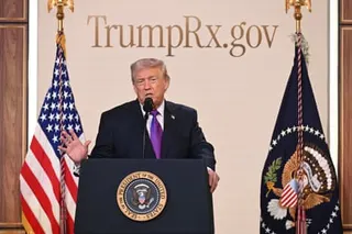 Donald Trump speaks at a presidential podium flanked by American flags, beneath a banner reading 'TrumpRx.gov'