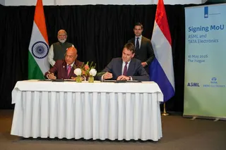 Tata Electronics CEO Randhir Thakur (bottom L) and ASML CEO Christophe Fouquet (bottom R) sign documents for the Memorandums of Understanding (MoU) as Indian Prime Minister Narendra Modi (topL) and Netherlands' Prime Minister Rob Jetten stand during an official visit of India's Prime Minister in The Hague on May 16, 2026. (Photo by Lina Selg / AFP)