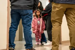 family members stand in a hallway