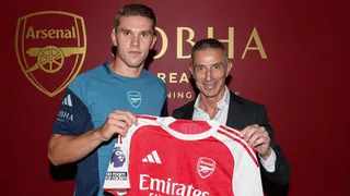 Viktor Gyokeres poses with the home shirt alongside sporting director Andrea Berta after signing for Arsenal
