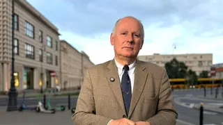 Paweł Zalewski standing and speaking in a formal setting