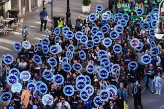people hold signs that say 'HTC'