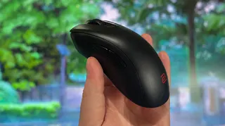 A Zowie EC2-DW gaming mouse in-hand.