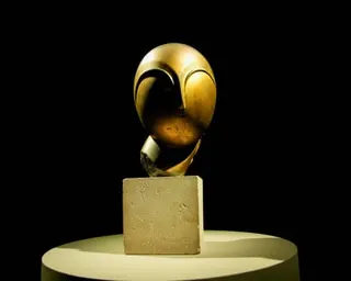 An abstract bronze head on a stone block