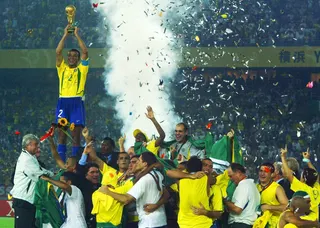 This file picture shows Brazil captain Cafu lifting the Fifa World Cup trophy as teammates celebrate after their 2-0 win over Germany in the 2002 final at the International Stadium Yokohama, Japan, June 30, 2002. — AFP pic