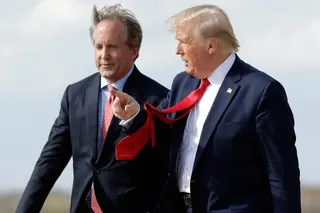 US President Donald Trump (right) walks with Texas Attorney General Ken Paxton at Austin-Bergstrom International Airport in Austin in November 2019. Photo: AP