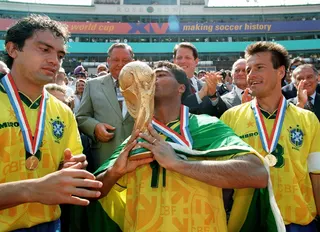 This file picture shows Brazil forward Romario kissing the Fifa World Cup trophy as teammates Branco (left) and Dunga look on after Brazil defeated Italy in the 1994 final at the Rose Bowl in Pasadena, July 17, 1994. — AFP pic