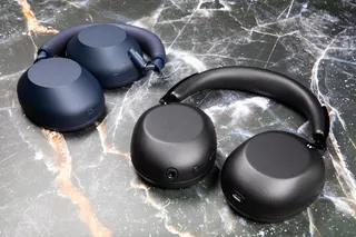 The Sony 1000X The Collexion headphones in black next to the WH-1000XM6 headphones in blue on a marble surface.
