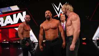 Austin Theory and Logan Paul standing with Bron Breakker and Paul Heyman at Greensboro Coliseum Complex