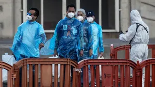 Medical staff direct some of the last passengers to be evacuated from the MV Hondius on May 11, 2026
