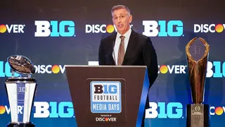 Big Ten Conference Commissioner Tony Petitti speaking at a podium indoors