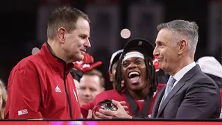 Big Ten Commissioner Tony Petitti presenting trophy to Curt Cignetti at Lucas Oil Stadium