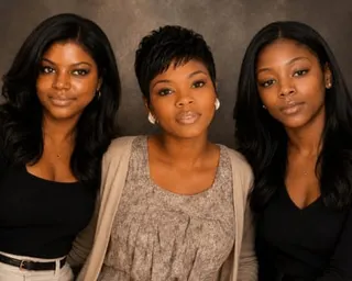 The three women pose together for a portrait photograph, two with long straight hair and one with short hair in the center