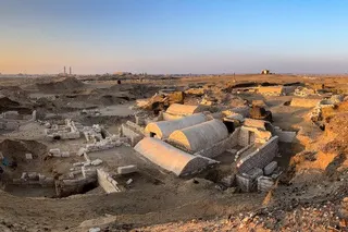 An elevated, wide-angle view of an archaeological site in Egypt at either dusk or dawn.