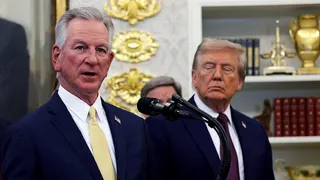 Sen. Tommy Tuberville speaking while President Donald Trump listens