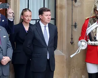 UK ambassador James Roscoe stands near a ceremonial guard in red uniform at Windsor Castle