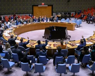 Security council representatives vote around a curved wooden table at the UN headquarters
