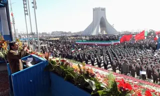 Mahmoud Ahmadinejad delivers a speech to a large crowd including many in uniform
