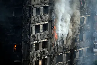 The fire burned for many hours after the deadly blaze swept through the high rise block. Photo: AP