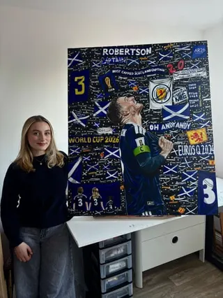 Abigail Rudkin with the painting she did of Andy Robertson, for Andy Robertson