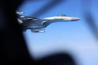 A handout picture released by Britain's Ministry of Defence (MOD) in London on May 20, 2026 shows Image of a Russian Su-35, seen here alongside an RAF Rivet Joint aircraft over the Black Sea in April 2026.
