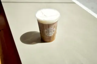 a cold coffee drink in a plastic cup