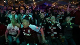 Aston Villa fans celebrate in a pub