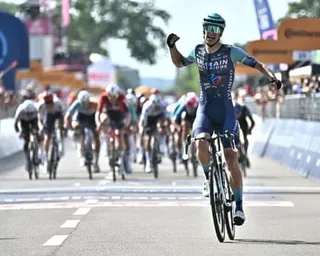 Belgian rider Alec Segaert of Bahrain Victorious team crosses the line to win the 12th stage