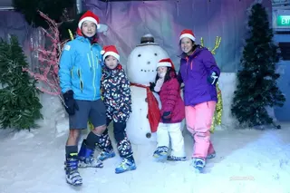 Ms Emeline Tan with her family at Snow City in 2009.