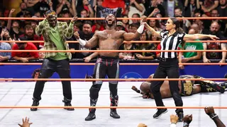 Referee Aubrey Edwards raising Swerve Strickland's hand in a wrestling ring
