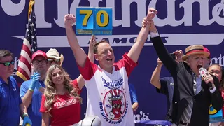 Joey Chestnut eating hot dogs at Nathan's Hot Dog Eating Contest in New York City