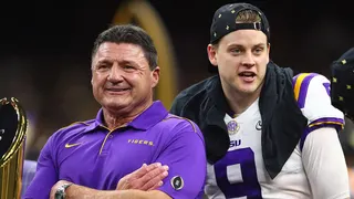 LSU Tigers head coach Ed Orgeron standing with quarterback Joe Burrow at Mercedes-Benz Superdome