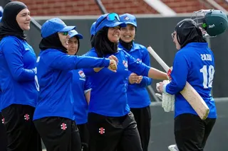 Afghan players congratulate top scoring batter Zazai as she walks off the field during their match against Cricket Without Borders XI at Junction Oval, Melbourne, Australia in 2025