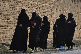 Afghan schoolgirls walk along a road in Balkh province. Photo: AFP