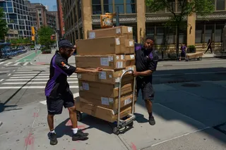 Workers move packages on Tuesday in New York. Photo: AP