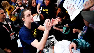 Indiana Fever guard Caitlin Clark signing autographs for fans
