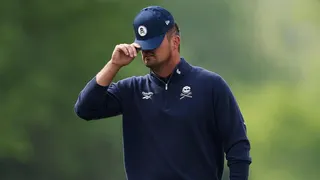 Bryson DeChambeau reacting after a putt on the 13th green at Aronimink Golf Club