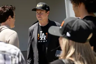 a man speaks with supporters