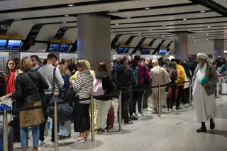 LONDON, ENGLAND - JUNE 01: Travellers wait in a long queue to pass through the security check at Heathrow on June 1, 2022 in London, England. The aviation industry is struggling to recruit staff after waves of layoffs during the Covid-19 pandemic. In the UK, Transport Secretary Grant Shapps said that airlines and operators have "seriously oversold flights and holidays" relative to their capacity to deliver as the country approaches the Jubilee holiday weekend. (Photo by Carl Court/Getty Images)