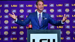 Lane Kiffin speaking at a press conference at Tiger Stadium in Baton Rouge