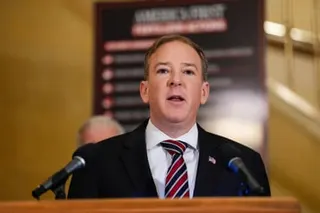 a man speaks into microphones