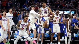 Florida Gators basketball players celebrating on bench during game against Maryland Terrapins