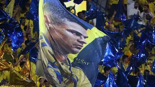 Fans wave a flag with picture of Nassr's Portuguese forward Cristiano Ronaldo